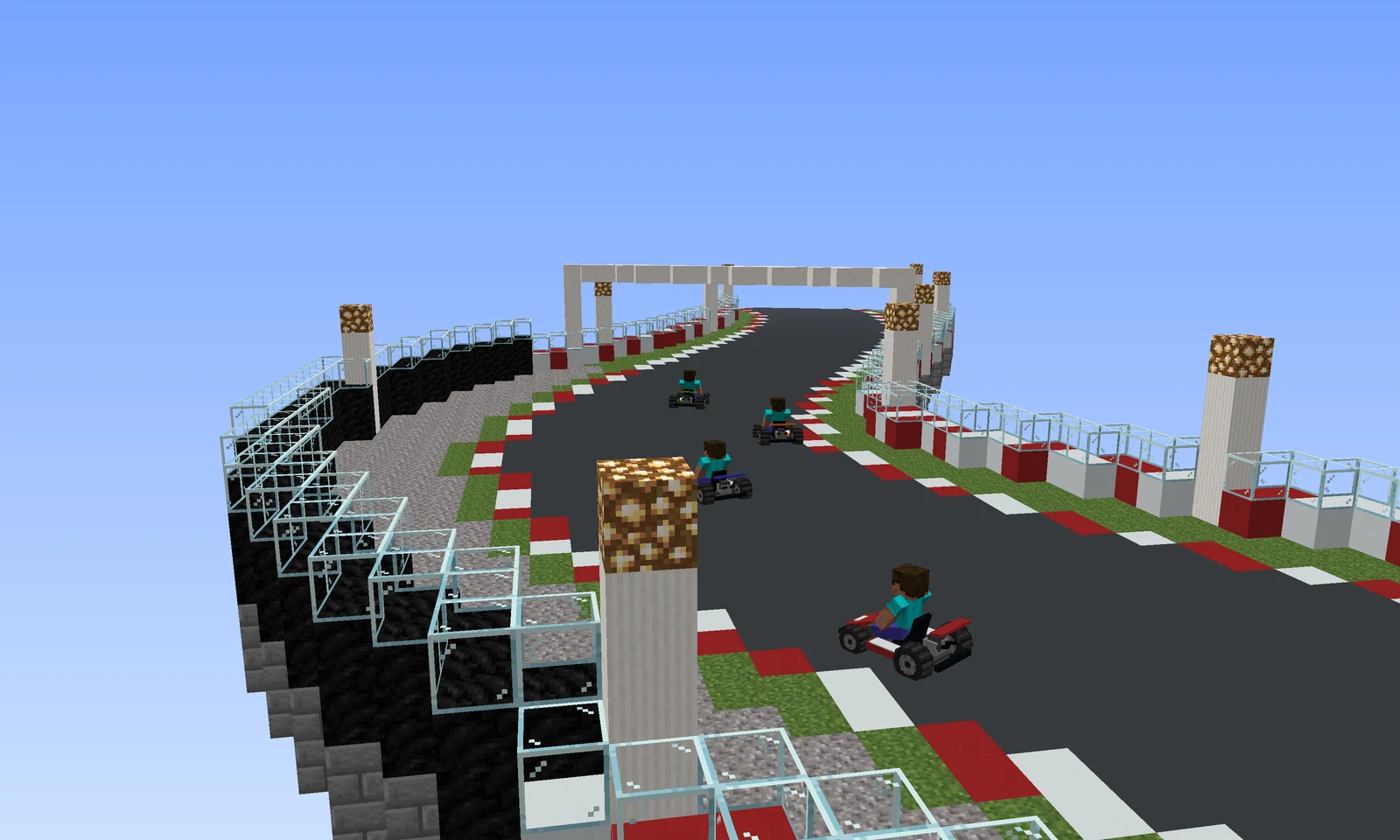Karts taking a tight corner with kerbs, a gravel trap and a tyre wall on the outside